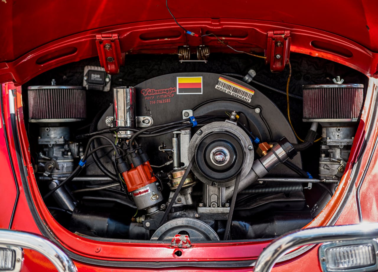 Detailed view of a classic Volkswagen Beetle engine, displaying intricate components and vibrant color.